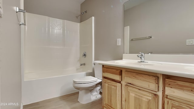 full bathroom with shower / bathing tub combination, wood-type flooring, vanity, and toilet