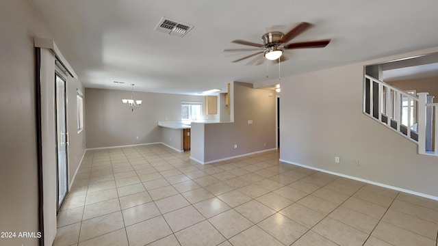 unfurnished living room featuring light tile patterned floors and ceiling fan with notable chandelier