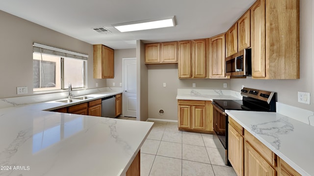 kitchen featuring light tile patterned flooring, sink, stainless steel appliances, and light stone countertops