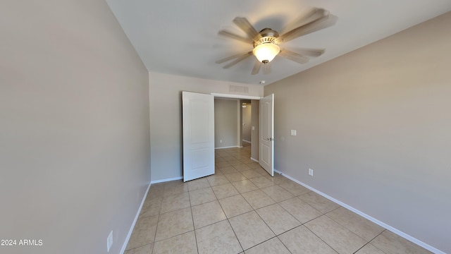 unfurnished bedroom with ceiling fan and light tile patterned flooring