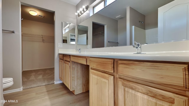 bathroom featuring vanity, wood-type flooring, and toilet