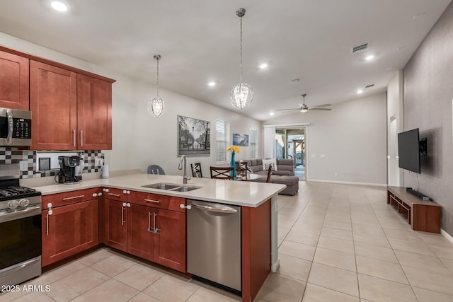 4152 W Bradshaw Creek Ln, New River, AZ 85087 - kitchen featuring appliances with stainless steel finishes, light tile patterned floors, light countertops, ceiling fan, and recessed lighting