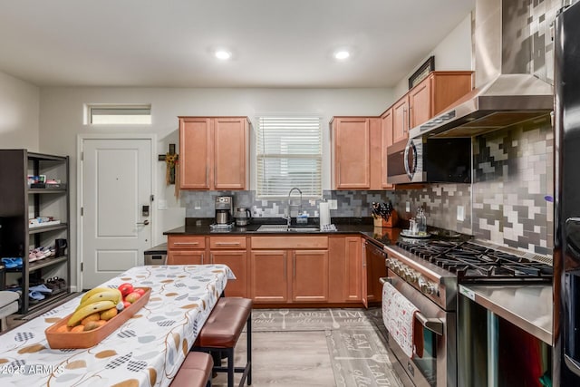 4152 W Bradshaw Creek Ln, New River, AZ 85087 - kitchen with stainless steel appliances, wall chimney range hood, healthy amount of natural light, tasteful backsplash, and recessed lighting