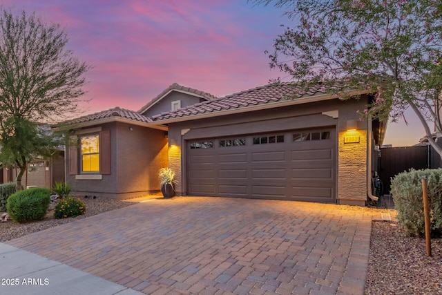 4152 W Bradshaw Creek Ln, New River, AZ 85087 - view of front of house featuring a garage, decorative driveway, stucco siding, and a tiled roof