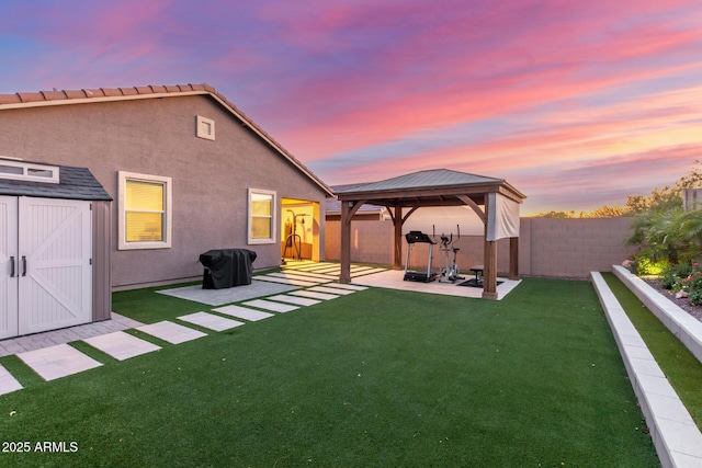4152 W Bradshaw Creek Ln, New River, AZ 85087 - back of house with a gazebo, a fenced backyard, a patio area, a shed, and stucco siding