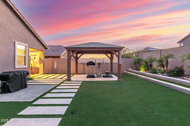 4152 W Bradshaw Creek Ln, New River, AZ 85087 - yard at dusk with a gazebo, a fenced backyard, and a patio area