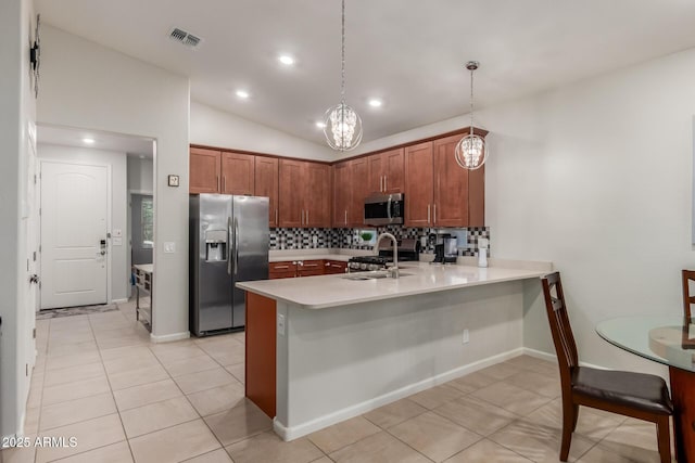 4152 W Bradshaw Creek Ln, New River, AZ 85087 - kitchen featuring appliances with stainless steel finishes, a peninsula, backsplash, light countertops, and a kitchen breakfast bar