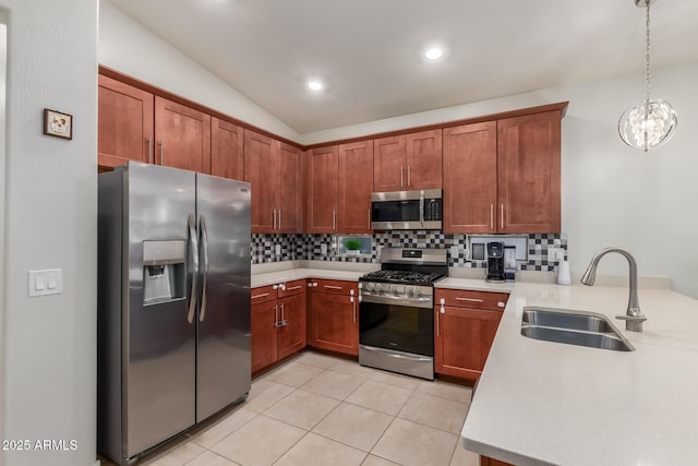 4152 W Bradshaw Creek Ln, New River, AZ 85087 - kitchen with appliances with stainless steel finishes, tasteful backsplash, light countertops, light tile patterned flooring, and decorative light fixtures