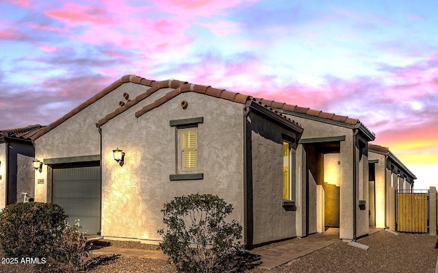 property exterior at dusk with a garage