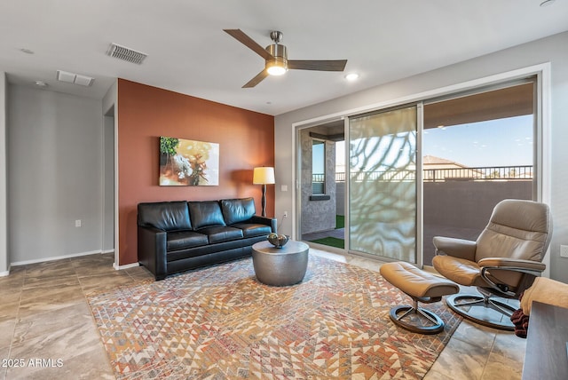 living room featuring ceiling fan and a healthy amount of sunlight