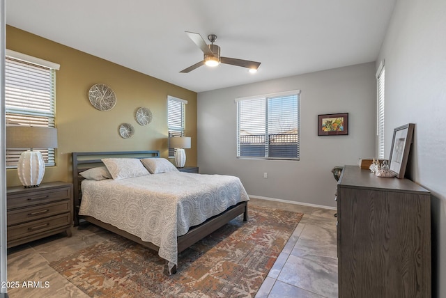 tiled bedroom featuring ceiling fan