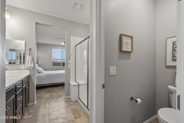 bathroom featuring toilet, an enclosed shower, and vanity