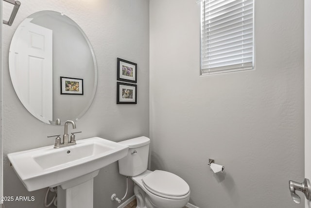 bathroom with sink and toilet