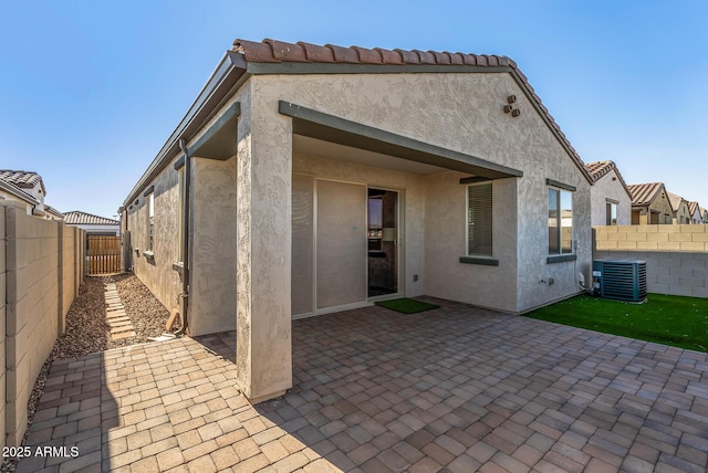 rear view of house featuring a patio area and central AC unit