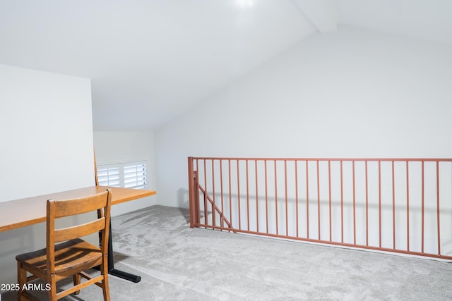 unfurnished office featuring carpet floors and vaulted ceiling