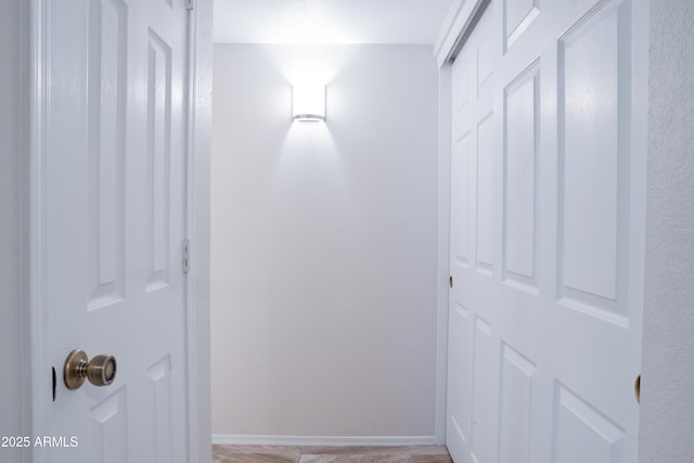 hall featuring baseboards