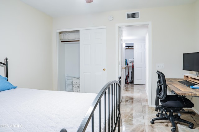 bedroom featuring visible vents, marble finish floor, baseboards, and a closet