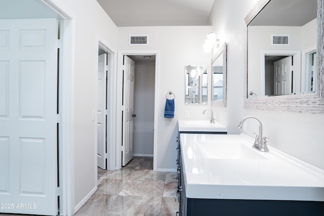 bathroom featuring visible vents, a sink, and marble finish floor