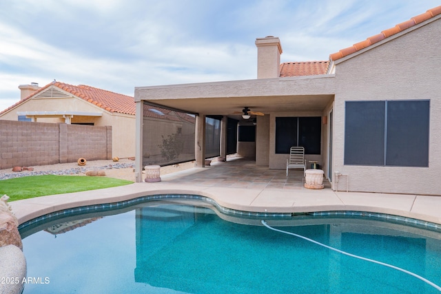 view of pool with fence, a fenced in pool, ceiling fan, and a patio