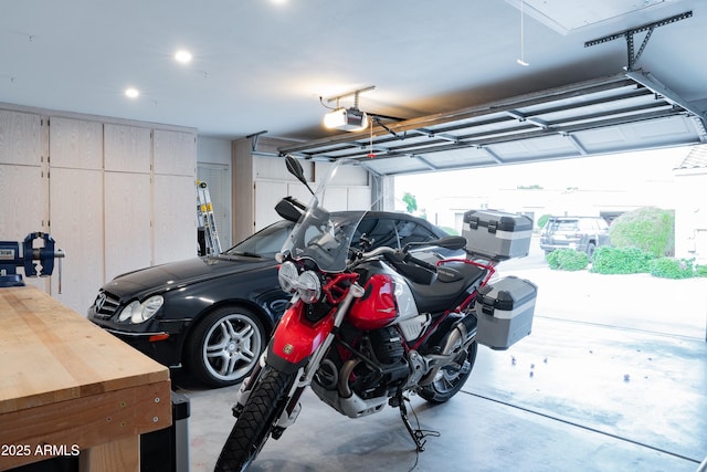 garage featuring recessed lighting and a garage door opener