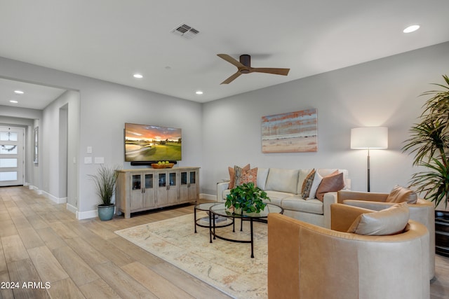 living room with light wood-type flooring and ceiling fan