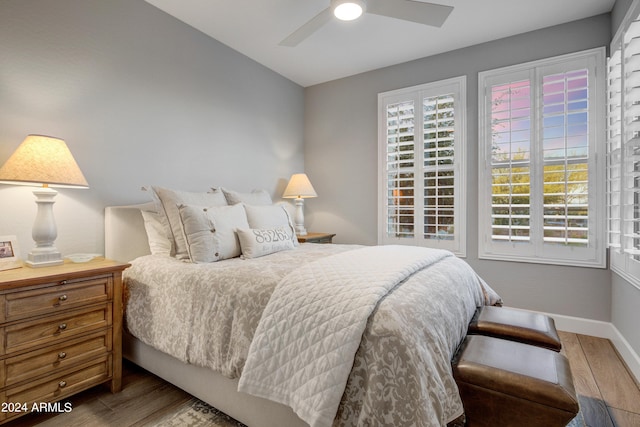 bedroom with ceiling fan and hardwood / wood-style floors