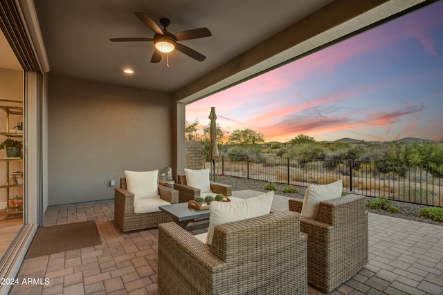 patio terrace at dusk with ceiling fan and outdoor lounge area