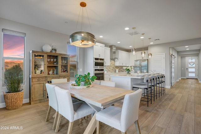 dining space with light wood-type flooring