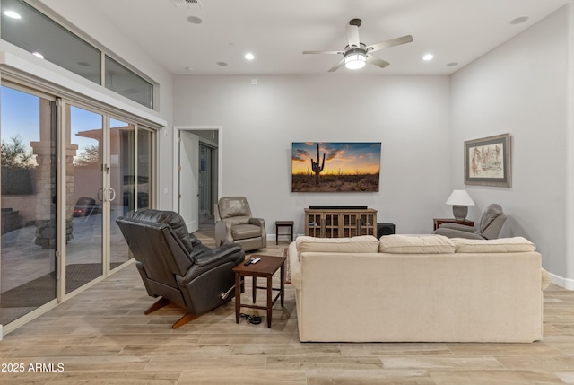 living room with ceiling fan and light hardwood / wood-style floors