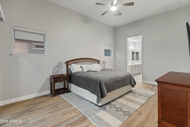 bedroom with ceiling fan, light wood-type flooring, and connected bathroom