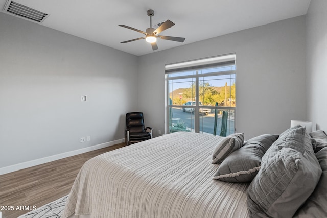 bedroom with ceiling fan and wood-type flooring