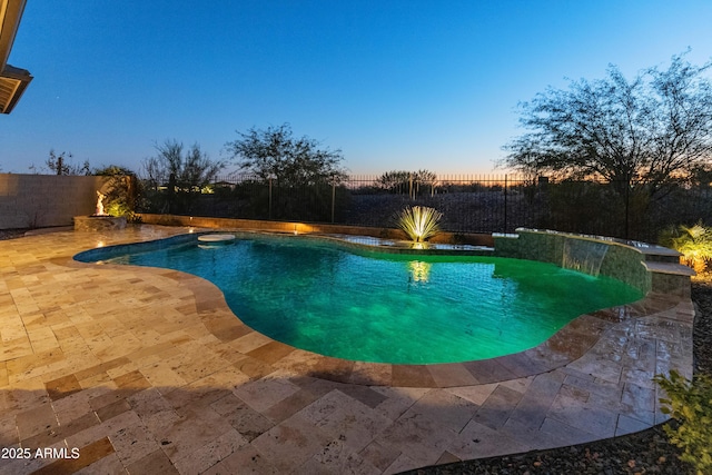 pool at dusk with a patio area