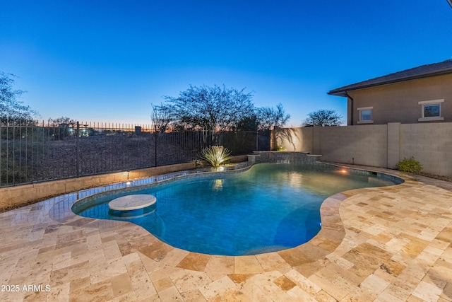 pool at dusk with a patio area