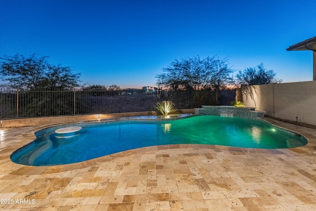 pool at dusk with a patio area