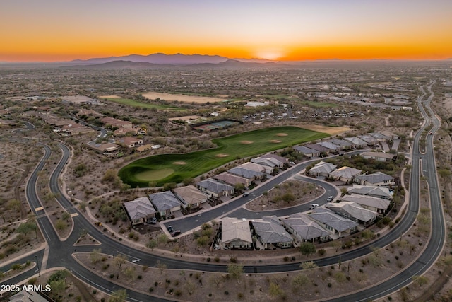 aerial view at dusk featuring a mountain view