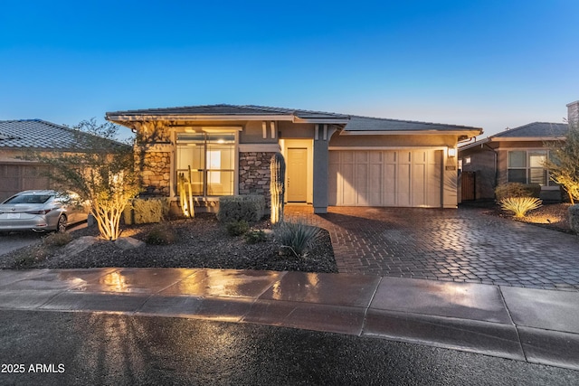 prairie-style home featuring a garage