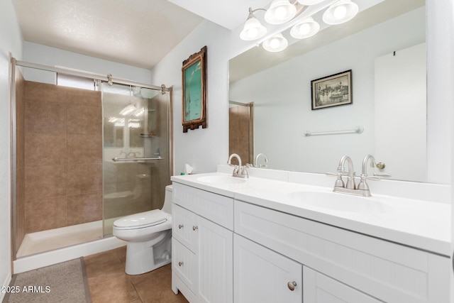 full bath with a stall shower, a sink, toilet, and tile patterned floors