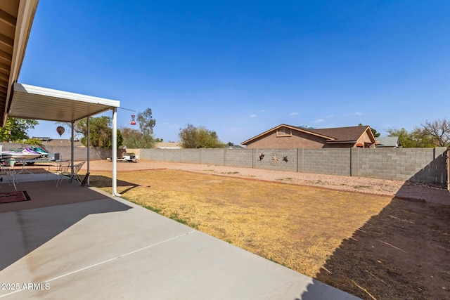 view of yard featuring a patio area and a fenced backyard