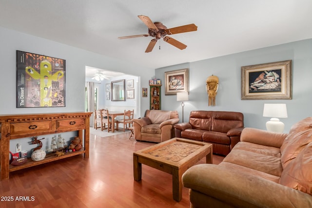 living area with ceiling fan and wood finished floors