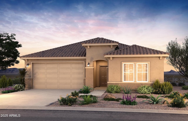 17809 W Getty Dr, Goodyear, AZ 85338 - view of front facade featuring a garage, a tiled roof, stucco siding, and concrete driveway