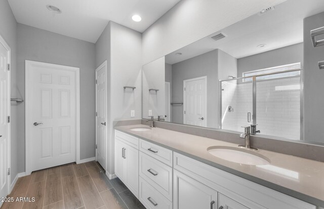 17809 W Getty Dr, Goodyear, AZ 85338 - bathroom with a shower stall, visible vents, baseboards, and a sink