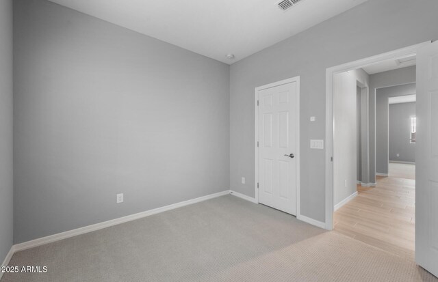 17809 W Getty Dr, Goodyear, AZ 85338 - spare room featuring light colored carpet, baseboards, and visible vents