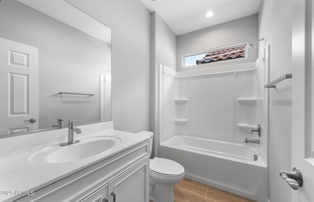 17809 W Getty Dr, Goodyear, AZ 85338 - full bathroom featuring toilet, vanity, wood finished floors, and shower / bath combination