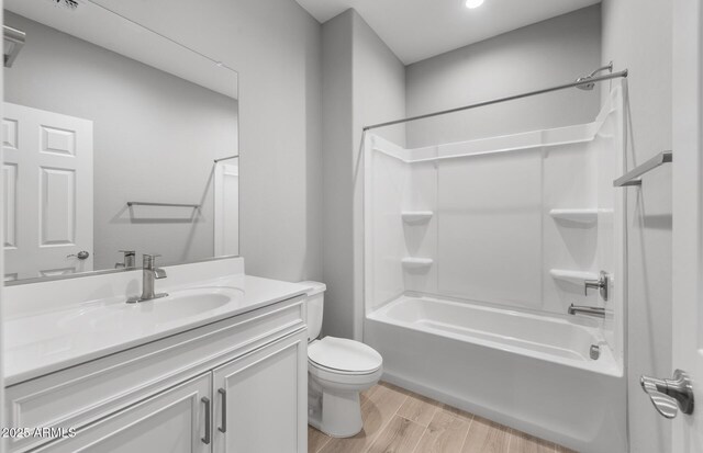 17809 W Getty Dr, Goodyear, AZ 85338 - full bathroom featuring toilet, vanity, wood finished floors, and shower / bathing tub combination