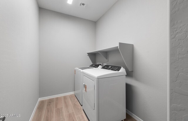 17809 W Getty Dr, Goodyear, AZ 85338 - laundry area featuring light wood finished floors, baseboards, visible vents, washer and dryer, and laundry area