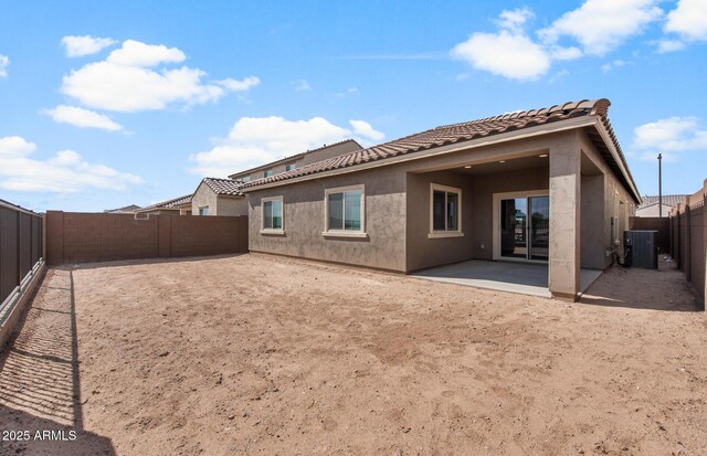 17809 W Getty Dr, Goodyear, AZ 85338 - back of house with stucco siding, a tiled roof, a fenced backyard, and central AC unit