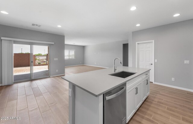 17809 W Getty Dr, Goodyear, AZ 85338 - kitchen featuring light wood-style floors, visible vents, stainless steel dishwasher, and a sink