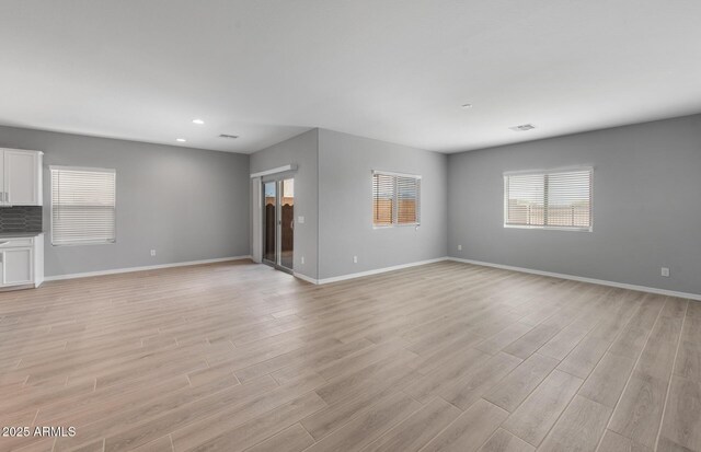17809 W Getty Dr, Goodyear, AZ 85338 - unfurnished living room with recessed lighting, light wood-type flooring, and baseboards