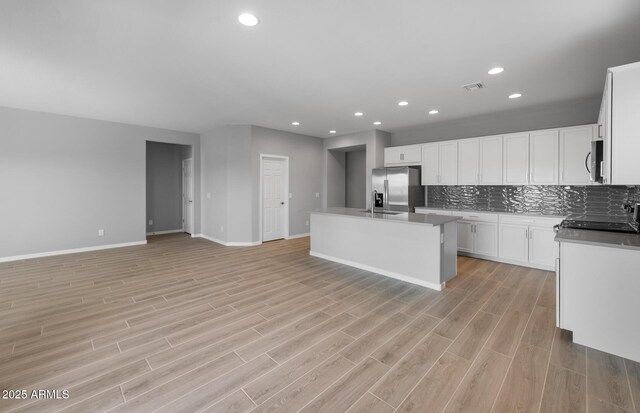 17809 W Getty Dr, Goodyear, AZ 85338 - kitchen with a sink, open floor plan, baseboards, backsplash, and appliances with stainless steel finishes
