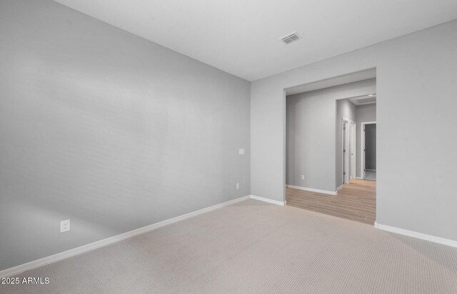 17809 W Getty Dr, Goodyear, AZ 85338 - spare room with light colored carpet, baseboards, and visible vents